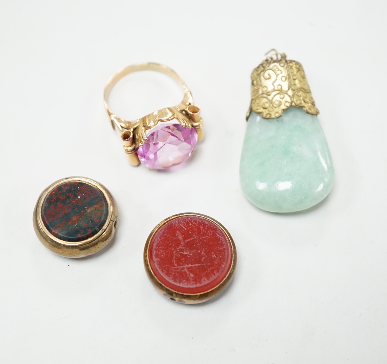 Two damaged carnelian set fobs and two other items including a yellow metal and pink stone ring.